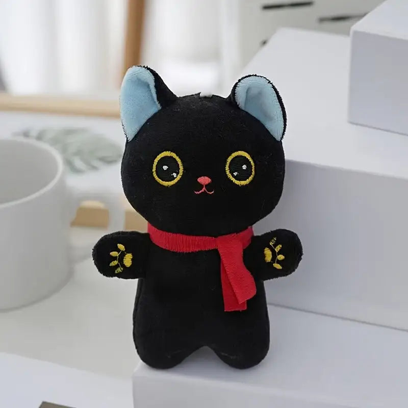 Black cat plush toy with red scarf, perfect as a durable kitten chewing plaything