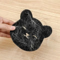 Black cat-shaped sponge with white hair, a pet hair remover for laundry ball washing