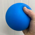 Blue jumbo stress ball being squeezed for anxiety relief and fun at the office