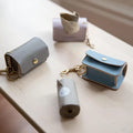 Pastel-colored NINA WOOF dog waste bag holders for eco-friendly puppy walks