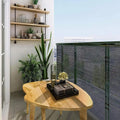 Balcony with wooden table displaying shade netting and sunblock shade cloth for outdoor use