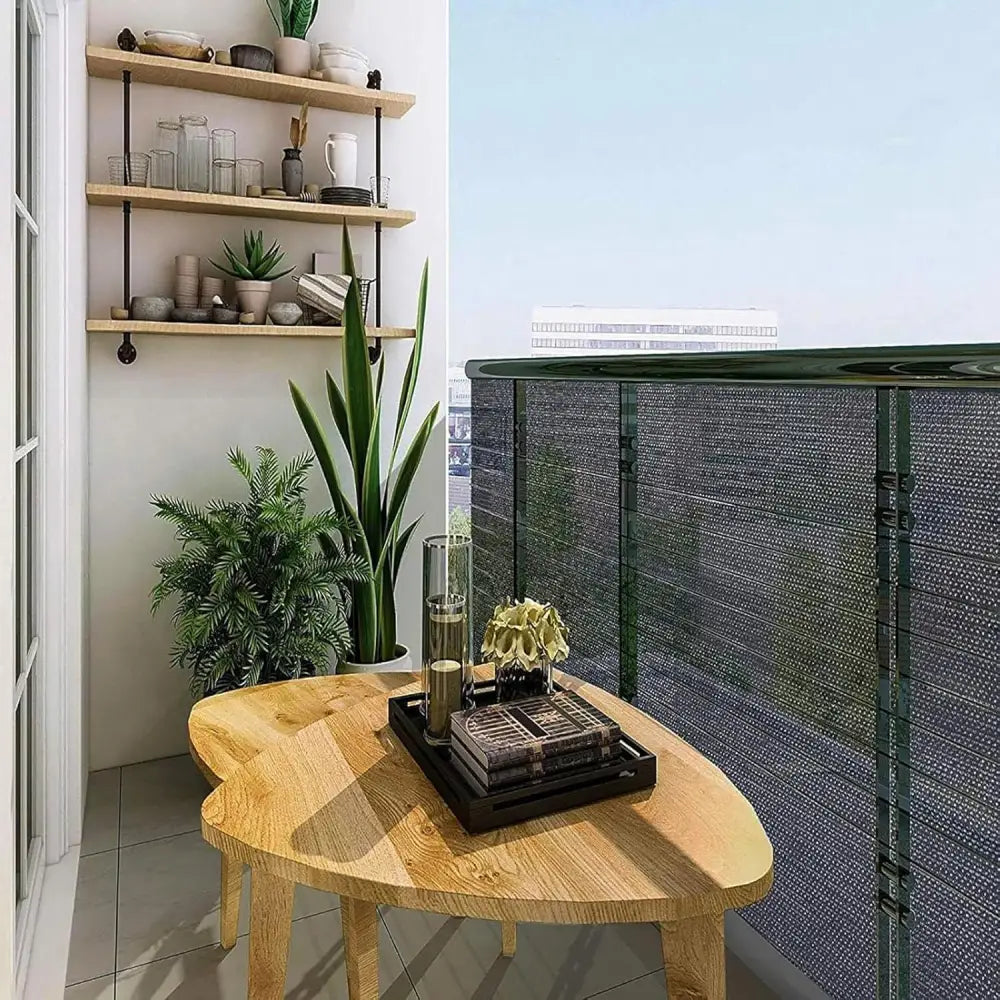 Balcony showcasing a shaded wooden table with shade netting and sunblock shade cloth