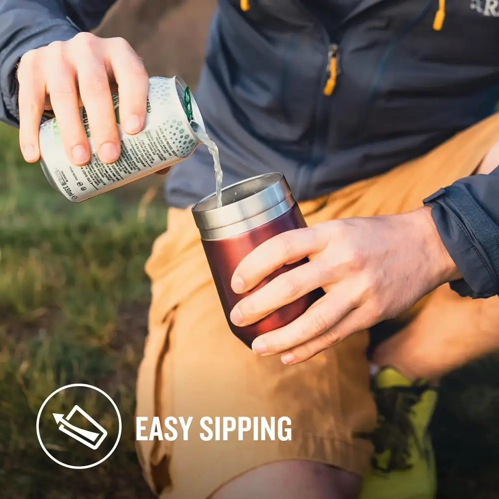 Person pouring a drink into a STANLEY stainless steel travel mug for everyday use